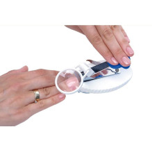 Nail clippers with magnifying glass